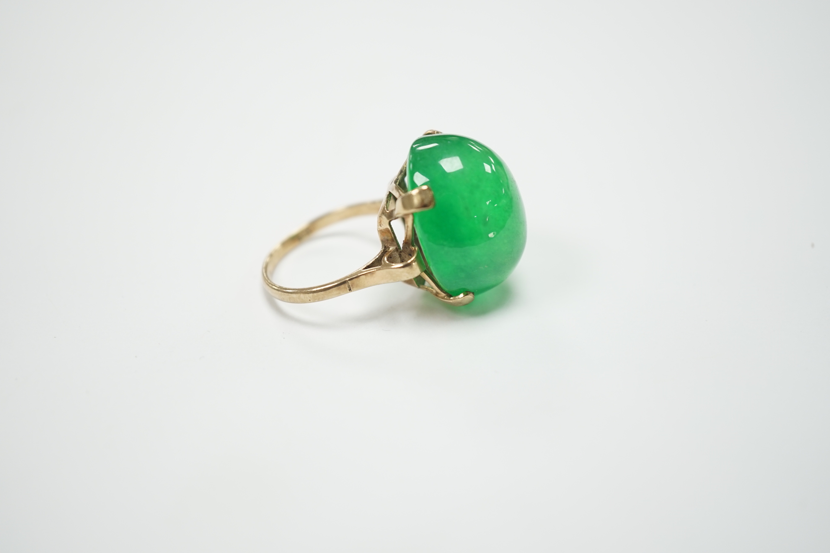 A 9ct and large cabochon oval jade set ring, size P/Q, gross weight 11.6 grams, the stone measuring approx. 21.1mm by 17.4mm, with a depth of 12.4mm.